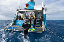 Research / Diving boat 'Undersea Explorer's back dive deck with divers, Great Barrier Reef, Queensland, Australia, 2007