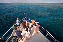 Research / Diving boat 'Undersea Explorer' with guests and crew at the bow of the boat in Cod Hole, Great Barrier Reef, Queensland, Australia, 2007