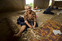 Woman weaving mats with pandanus leaves, Tonga, Melanesia, 2007