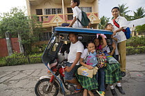 Tricycle full of school children going home after school, Camarines Sur, Luzon, Philippines 2008