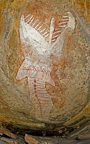 Aboriginal rock art painting of a massive rainbow serpent painted on the roof of a cavern extends deep into the sandstone overhang. Note the people at the bottom of the frame, Main Art Site, Mt Borrad...