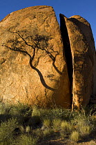 The Devils Marbles, a series of sandstone rocks perched at seemingly impossible angles, sacred to the regional Aboriginal people. Split by weather,  Devils Marbles Conservation Park, Northern Territor...