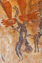 Ancient Wandjina figures painted over a much older panel of Bradshaw rock art, Northern Kimberley region and the Mitchell Plateau, Western Australia .
