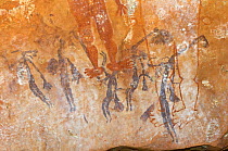 Ancient Wandjina figures painted over a much older panel of Bradshaw rock art, Northern Kimberley region and the Mitchell Plateau, Western Australia