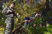 Siberian tiger anti-poaching patrol with arrested poachers (with secret police for extra protection), 600 miles north of Vladivostok, Primorksy, Russian Far East, October 2005