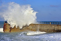 Wave crashing over jetty during storm at Saint-Valéry-en-Caux, Normandy, France, December 2008