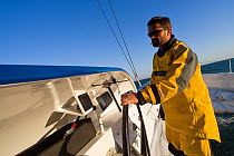 Helming aboard Maxi yacht "Banque Populaire V", skippered by Pascal Bidegorry, practicing off Cadiz, Spain. March 2009.