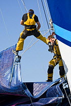 Crew member being winched aloft aboard Maxi yacht "Banque Populaire V", skippered by Pascal Bidegorry, practicing off Cadiz, Spain. March 2009.