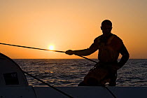 Hauling a rope aboard Maxi yacht "Banque Populaire V", skippered by Pascal Bidegorry, practicing off Cadiz, Spain. March 2009.