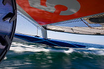 View from beneath trampoline aboard Maxi yacht "Banque Populaire V", skippered by Pascal Bidegorry, practicing off Cadiz, Spain. March 2009.