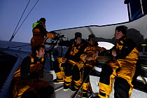 The crew at night aboard Maxi yacht "Banque Populaire V", skippered by Pascal Bidegorry, practicing off Cadiz, Spain. March 2009.