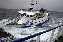 MFV coming alongside partner vessel to start pair trawling operations. North Sea, 2008. Property released.
