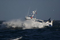 Fishing vessel in heavy seas, heading back to port for fish auction. North Sea, 2008.  Property released.