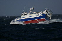 Fishing vessel "Ocean Harvest" rolling to starboard in heavy seas, North Sea, October 2008.  Property Released.