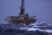 Oil drilling rig "John Shaw", situated at the Don oilfield 240 miles North East of Aberdeen, in heavy seas. North Sea, 2009.