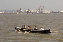 "Bedehaven" rowers in the Bristol Gig Club "Bristol Challenge" race with Portbury Docks in the background. March 21st 2009.