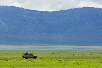 Four wheel drive safari with tourists watching wildlife in the Ngorongoro crater, Tanzania, February 2009