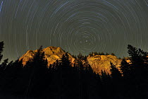 Mountains with star trails in the sky, Cheile Bicazului-Hasmas National Park, Carpathian Mountains, Transylvania, Romania, October 2008. WWE OUTDOOR EXHIBITION.