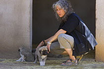 Dr. Laurie Marker with Anatolian Shepherd Dog puppies, (Cheetah conservationists currently use Anatolian shepherds to protect livestock from cheetah attack) Cheetah Conservation Fund, Namibia