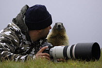 Photographer, Grzegorz Lesniewski with marmot, model released, Hohe Tauern National Park, July 2008 WWE OUTDOOR EXHIBITION. WWE BOOK.
