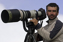 Photographer, Grzegorz Lesniewski with his camera, model released, Hohe Tauern National Park, July 2008