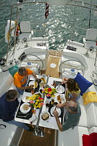 Friends eating breakfast aboard Stephens 53 in Florida Bay, Florida, USA.  Model and property released.