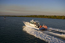 Surf Hunter 33 Jet boat off Marco Island, Florida. Model and property released.