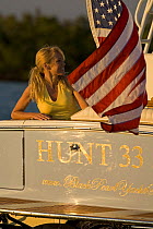Woman aboard Surf Hunter 33 Jet boat off Marco Island, Florida. Model and property released.