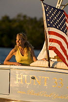 Woman aboard Surf Hunter 33 Jet boat off Marco Island, Florida. Model and property released.