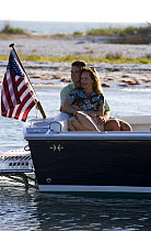 Couple relaxing in the cockpit of Hunt Harrier 25 off Marco Island, Florida, USA. Model and property released, 2007.