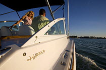 Couple helming Hunt Harrier 25 off Marco Island, Florida, USA. Model and property released, 2007.