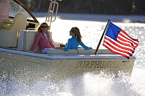 Women relaxing in the cockpit of a Surf Hunter 29 Inboard off Marco Island, Florida, USA. Model and property released, 2007.