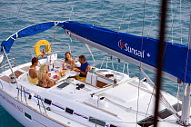 Friends eating breakfast in cockpit of Sunsail Oceanis 423, British Virgin Islands. Model released and property released, March 2006.