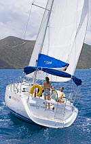 Couple cruising on Sunsail Oceanis 423 yacht "Insolent Too", British Virgin Islands. Model released and property released, March 2006.