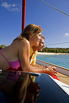Couple relaxing on a yacht in the British Virgin Islands, Caribbean. Model released, March 2006.