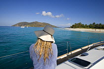 Woman looking at the coastline of the British Virgin Islands from aboard a yacht, March 2006.