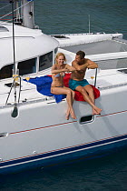 Couple onboard a Sunsail yacht cruising in the British Virgin Islands, Caribbean. Model released, March 2006.