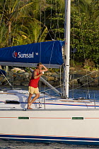 Man relaxing with a cup of tea on deck of a Sunsail yacht, British Virgin Islands, April 2006.