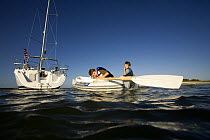 Children in tender behind Hunter 49 yacht off St. Augustine, Florida, USA.