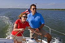 Father and daughter helming a Hunter 49 yacht off St. Augustine, Florida, USA. Model and Property released, 2006.