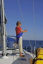 Woman aboard a yacht sailing from San Juanico to Puerto Escondito, Baja California, Mexico. Model Released, March 2005.