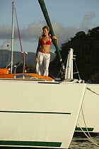Girl in bikini on board Lagoon 470 Sunsail charter catamaran "KooLau", anchored off the British Virgin Islands, January 2004. Model released.