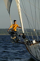 Boy in pulpit of Shannon 42 yacht sailing in Narragansett Bay, Newport, Rhode Island. June 2005.  Model and property released.