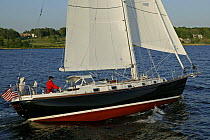 Man helming Shannon 42 yacht sailing in Narragansett Bay, Newport, Rhode Island. June 2005.
