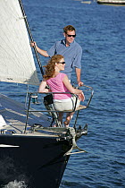 Couple in pulpit of Swan 60 "Extraordinary", sailing on Narragansett Bay, Rhode Island. Model Released, July 2005.