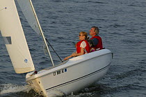 Family sailing Hunter 170 dinghy near Stonington, Connecticut, USA. August 2004.  Model and property released.