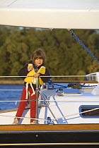 Child in lifejacket aboard Tartan 4300 "Tsunami" on the Severn River, Maryland. Model released, October 2007.