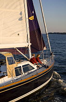 Two girls on foredeck of Tartan 4300 "Tsunami" on the Severn River, Maryland. Model and property released, October 2007.