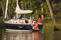 Family on stern of Tartan 4300 "Tsunami", with the transom door open. Back Creek, Maryland. Model and property released, October 2007.