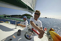 Two men sailing onboard Lagoon 470 yacht, British Virgin Islands, January 2004. Model and property released.